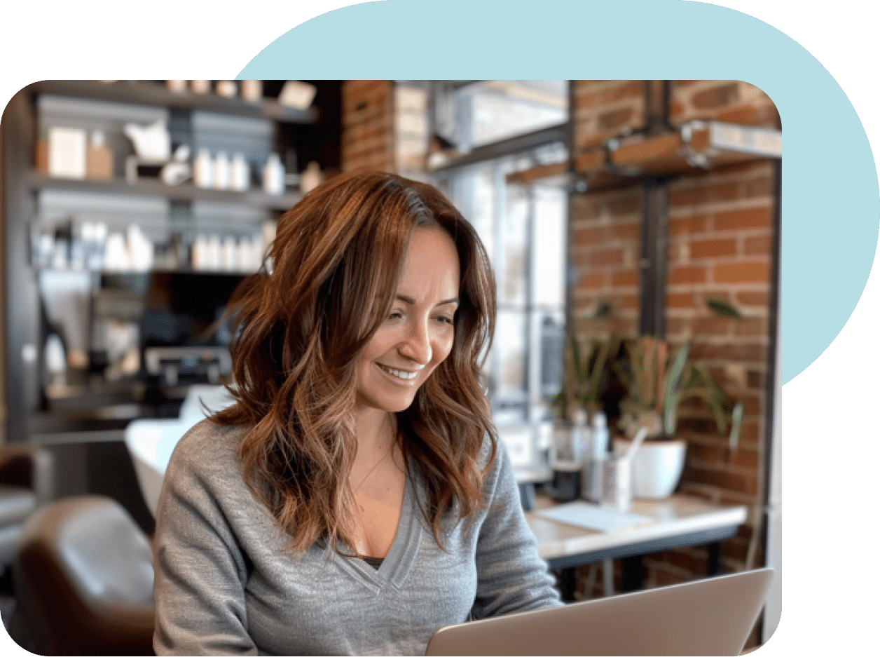 woman using laptop in a salon